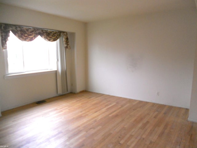 spare room with light wood-type flooring