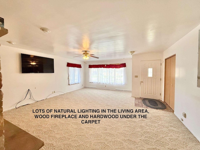 unfurnished living room with a ceiling fan and carpet