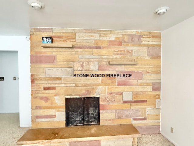 room details with a stone fireplace, carpet flooring, and baseboards