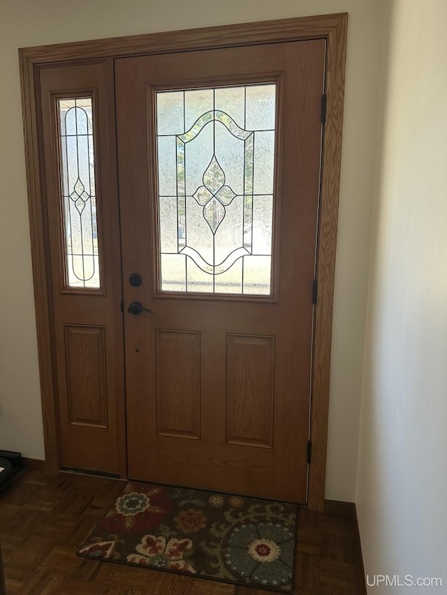 doorway to outside featuring baseboards