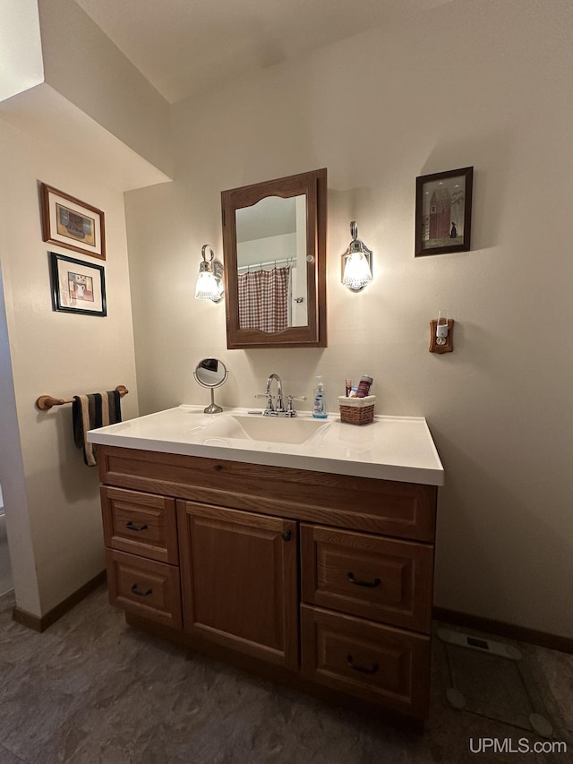 full bathroom featuring baseboards and vanity