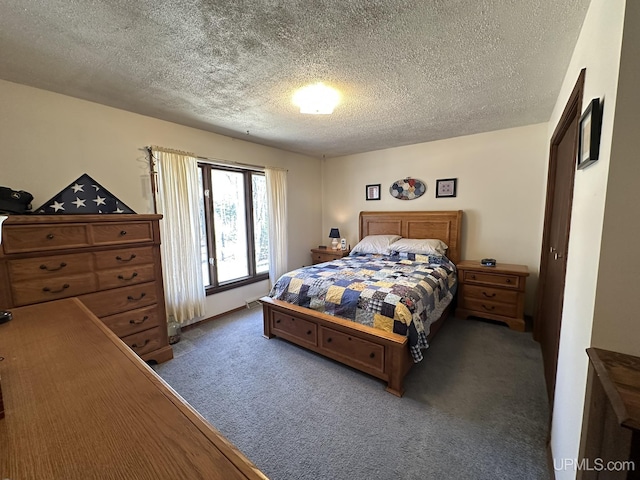carpeted bedroom featuring a textured ceiling