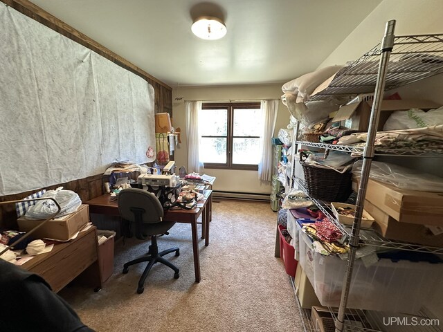 carpeted office with a baseboard heating unit