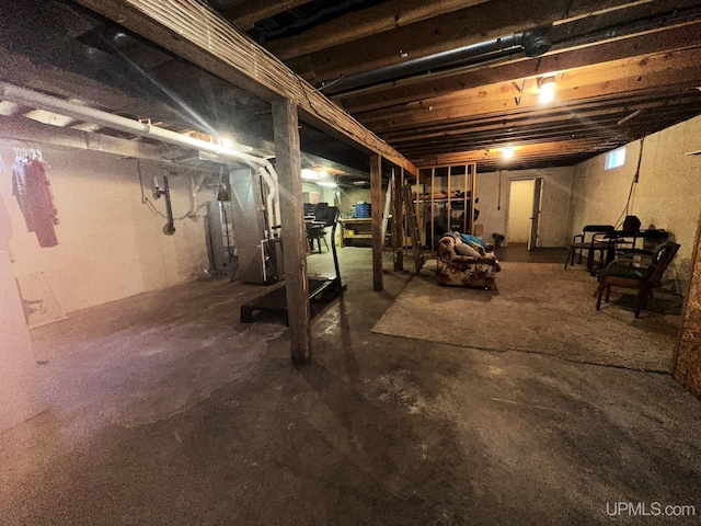 unfinished below grade area featuring heating unit