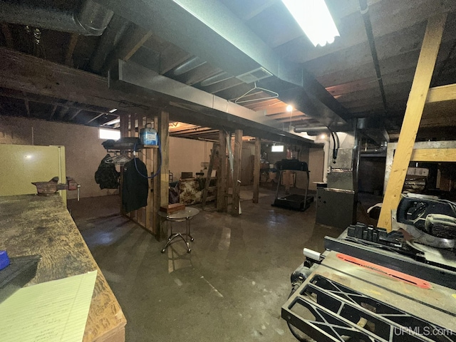 unfinished below grade area with freestanding refrigerator