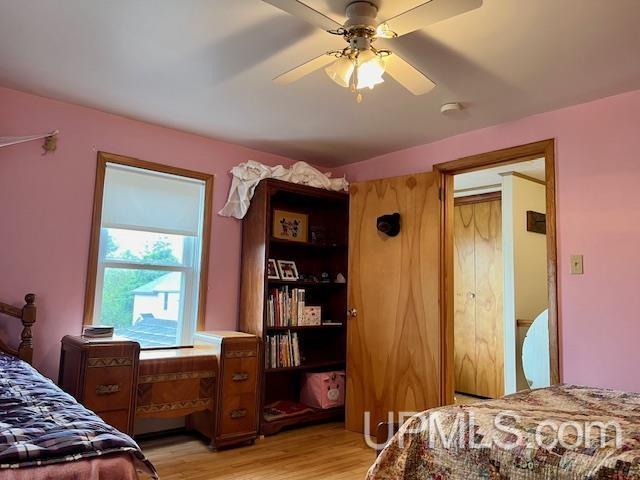 bedroom with a ceiling fan and light wood finished floors