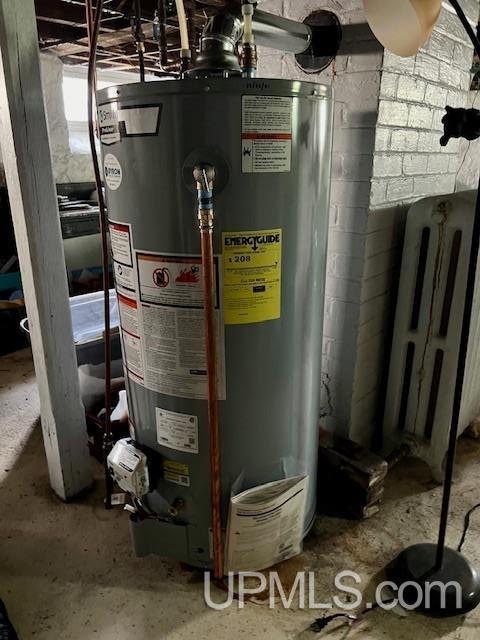 utility room featuring water heater