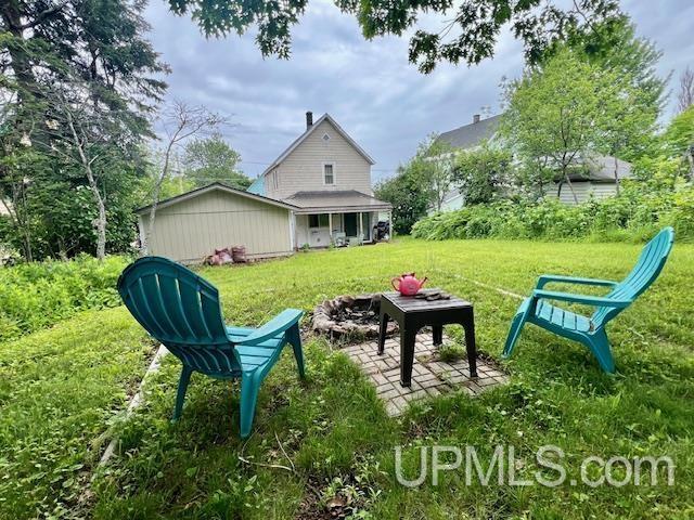 view of yard with a fire pit