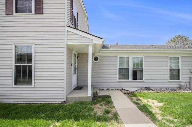 doorway to property featuring a yard