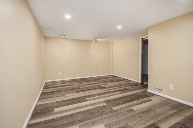 finished below grade area with baseboards, recessed lighting, wood finished floors, and visible vents