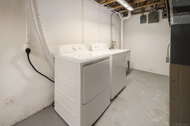 laundry room with separate washer and dryer, laundry area, heating unit, and electric panel