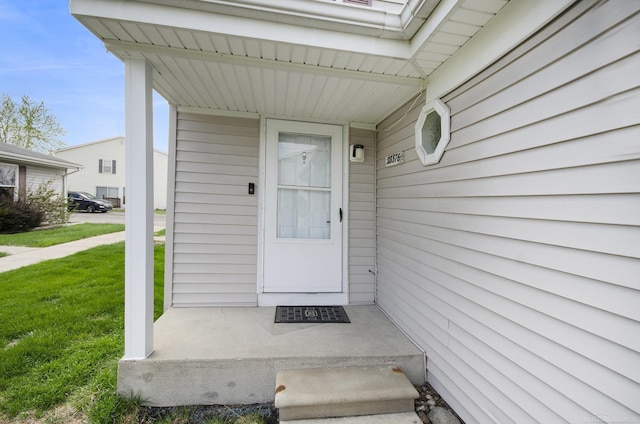 doorway to property with a yard