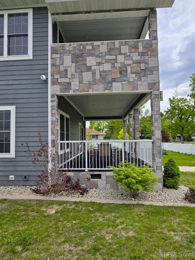 1812 Lake Shore Dr, Escanaba, MI 49829 - view of home's exterior featuring crawl space and a lawn