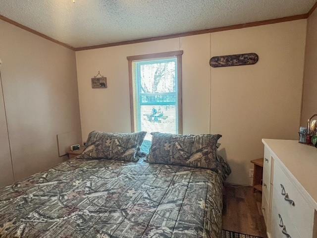 bedroom with a textured ceiling and ornamental molding
