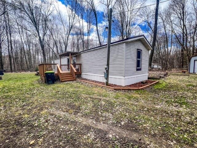 view of property exterior with a wooden deck