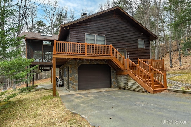 rustic home featuring aphalt driveway, stone siding, a garage, stairway, and log veneer siding