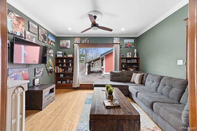 living area with a ceiling fan, ornamental molding, recessed lighting, and wood finished floors