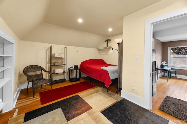 bedroom featuring vaulted ceiling, wood finished floors, baseboards, and recessed lighting