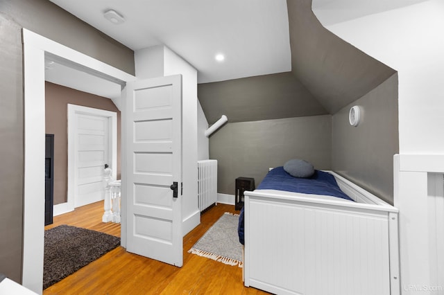 bedroom featuring lofted ceiling and wood finished floors