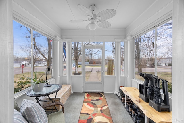 sunroom / solarium featuring ornate columns and plenty of natural light