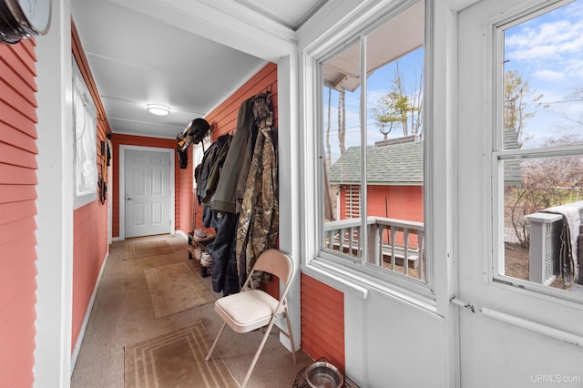 doorway to outside featuring baseboards