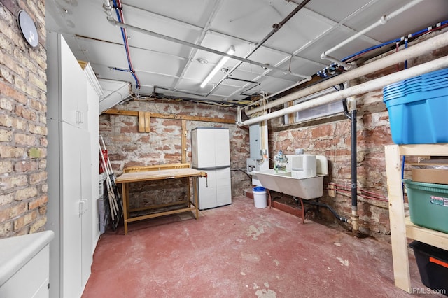 unfinished below grade area featuring brick wall and a sink