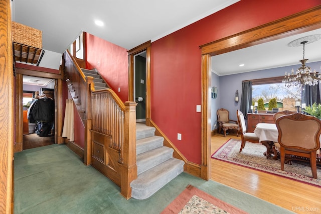 stairway with a chandelier, recessed lighting, baseboards, and wood finished floors