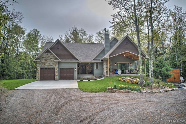 N9006 Sand River Rd, Deerton, MI 49822 - craftsman inspired home featuring stone siding, an attached garage, a chimney, aphalt driveway, and a front yard