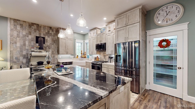 N9006 Sand River Rd, Deerton, MI 49822 - kitchen with dark stone countertops, wood finished floors, recessed lighting, pendant lighting, and appliances with stainless steel finishes