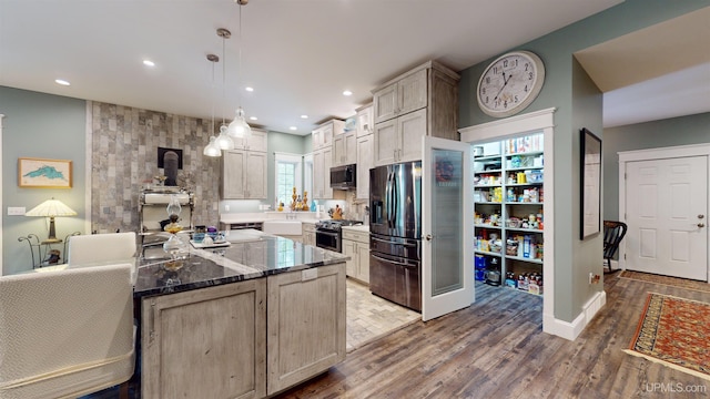 N9006 Sand River Rd, Deerton, MI 49822 - kitchen with wood finished floors, dark stone counters, decorative light fixtures, recessed lighting, and appliances with stainless steel finishes