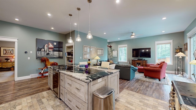 N9006 Sand River Rd, Deerton, MI 49822 - kitchen featuring a ceiling fan, light wood-style floors, recessed lighting, and a center island