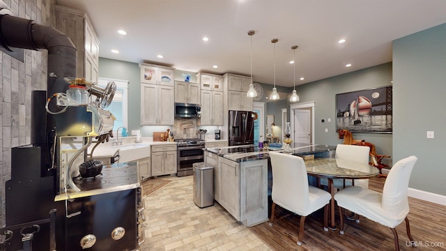 N9006 Sand River Rd, Deerton, MI 49822 - kitchen with glass insert cabinets, a sink, stainless steel appliances, a kitchen island, and recessed lighting