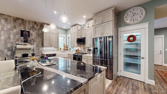 N9006 Sand River Rd, Deerton, MI 49822 - kitchen featuring light wood finished floors, stainless steel appliances, pendant lighting, a wood stove, and recessed lighting