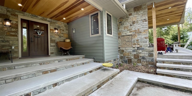 N9006 Sand River Rd, Deerton, MI 49822 - property entrance featuring stone siding and a porch
