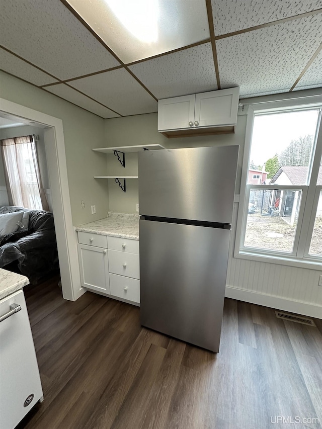 kitchen with freestanding refrigerator, open shelves, dark wood-style flooring, and a healthy amount of sunlight