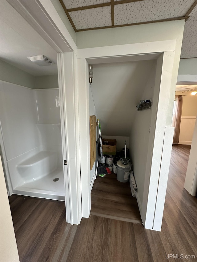 full bath with walk in shower, visible vents, and wood finished floors