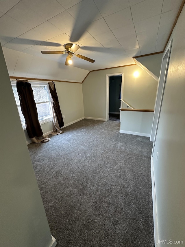 additional living space with vaulted ceiling, baseboards, ceiling fan, and carpet floors