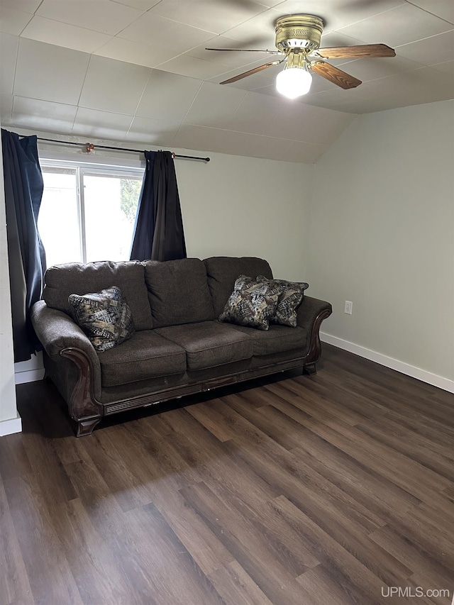 living room featuring lofted ceiling, baseboards, a ceiling fan, and dark wood finished floors