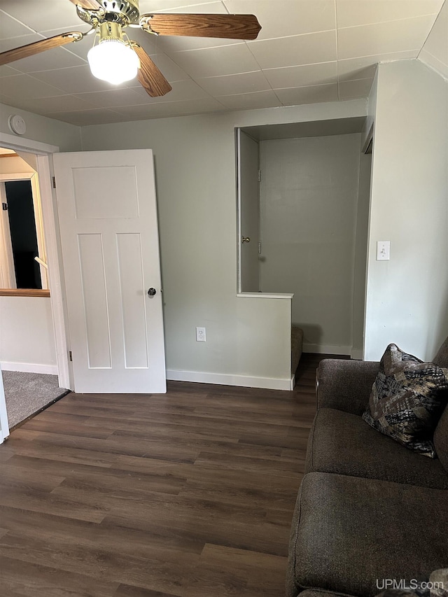 living room featuring baseboards, stairs, a ceiling fan, and wood finished floors