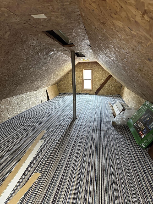 additional living space featuring lofted ceiling