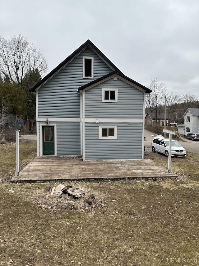 back of house featuring a deck