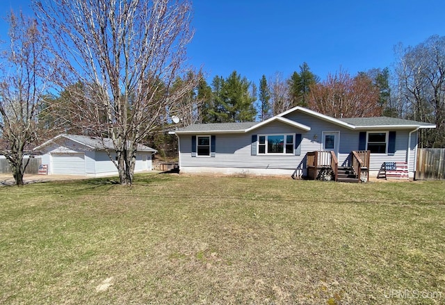 rear view of house featuring a yard, fence, and a shingled roof