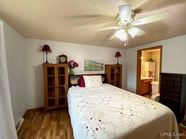 bedroom with connected bathroom, a textured ceiling, wood finished floors, and a ceiling fan