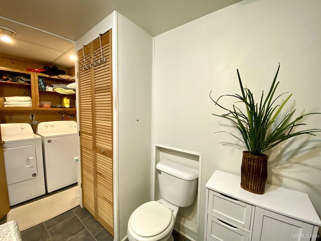 bathroom with separate washer and dryer, toilet, and tile patterned floors