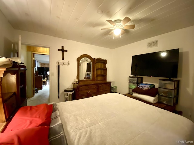 carpeted bedroom with ceiling fan and visible vents
