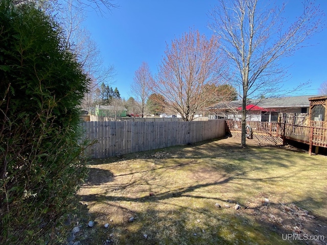 view of yard featuring fence and a deck