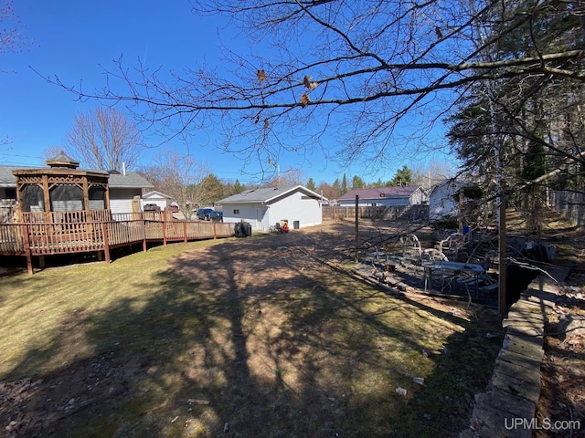 view of yard with fence, a gazebo, and a wooden deck