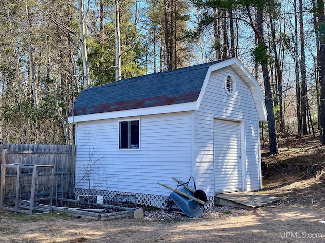view of shed featuring fence