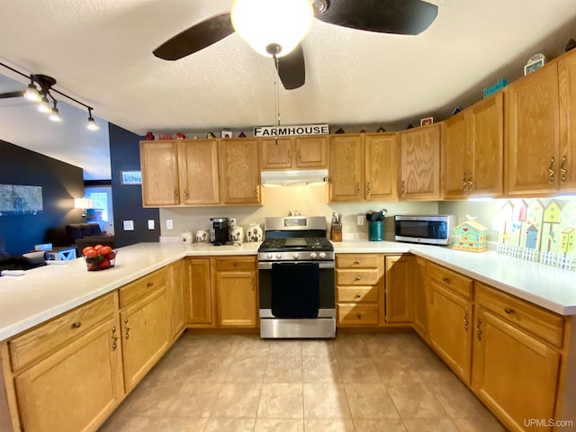 kitchen featuring light countertops, a peninsula, appliances with stainless steel finishes, and under cabinet range hood