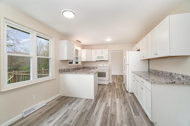 1983 Penrod Rd, Midland, MI 48640 - kitchen with light wood-style flooring, a sink, white cabinets, visible vents, and white appliances